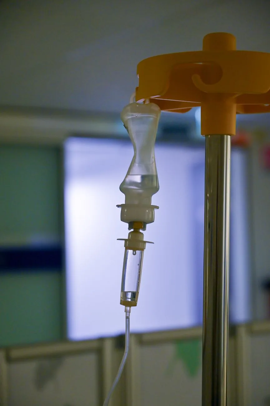 Poche de perfusion suspendue à sa potence dans une chambre de clinique